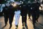 Des policiers arrêtent un suspect, lundi 25 septembre, à Corbeil-Essonnes, six jours après l'agression de deux CRS dans la cité des Tarterêts. | AFP/JOËL SAGET